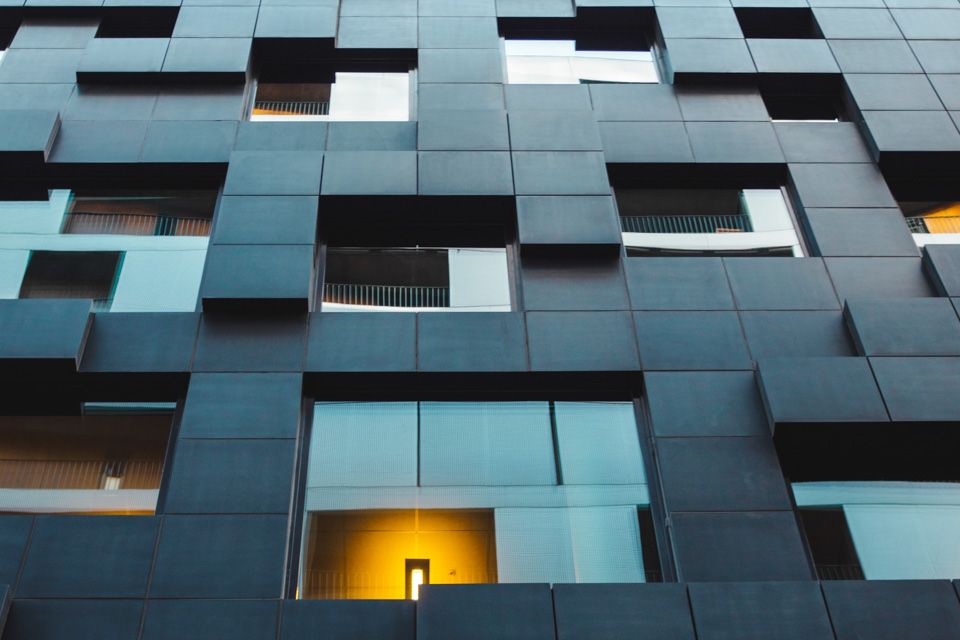 Black buidling seen from a worm's-eye view.