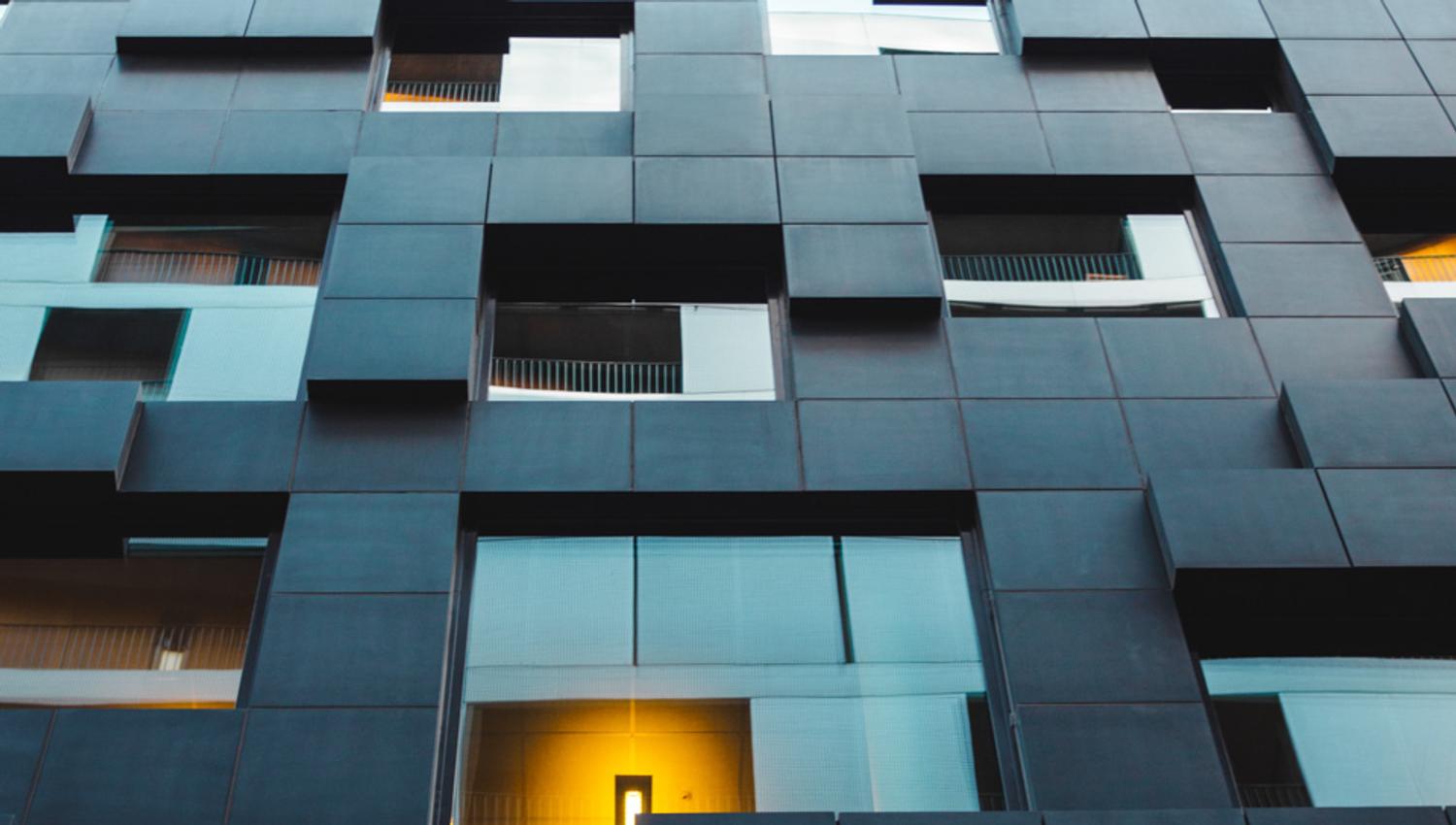 Black buidling seen from a worm's-eye view.