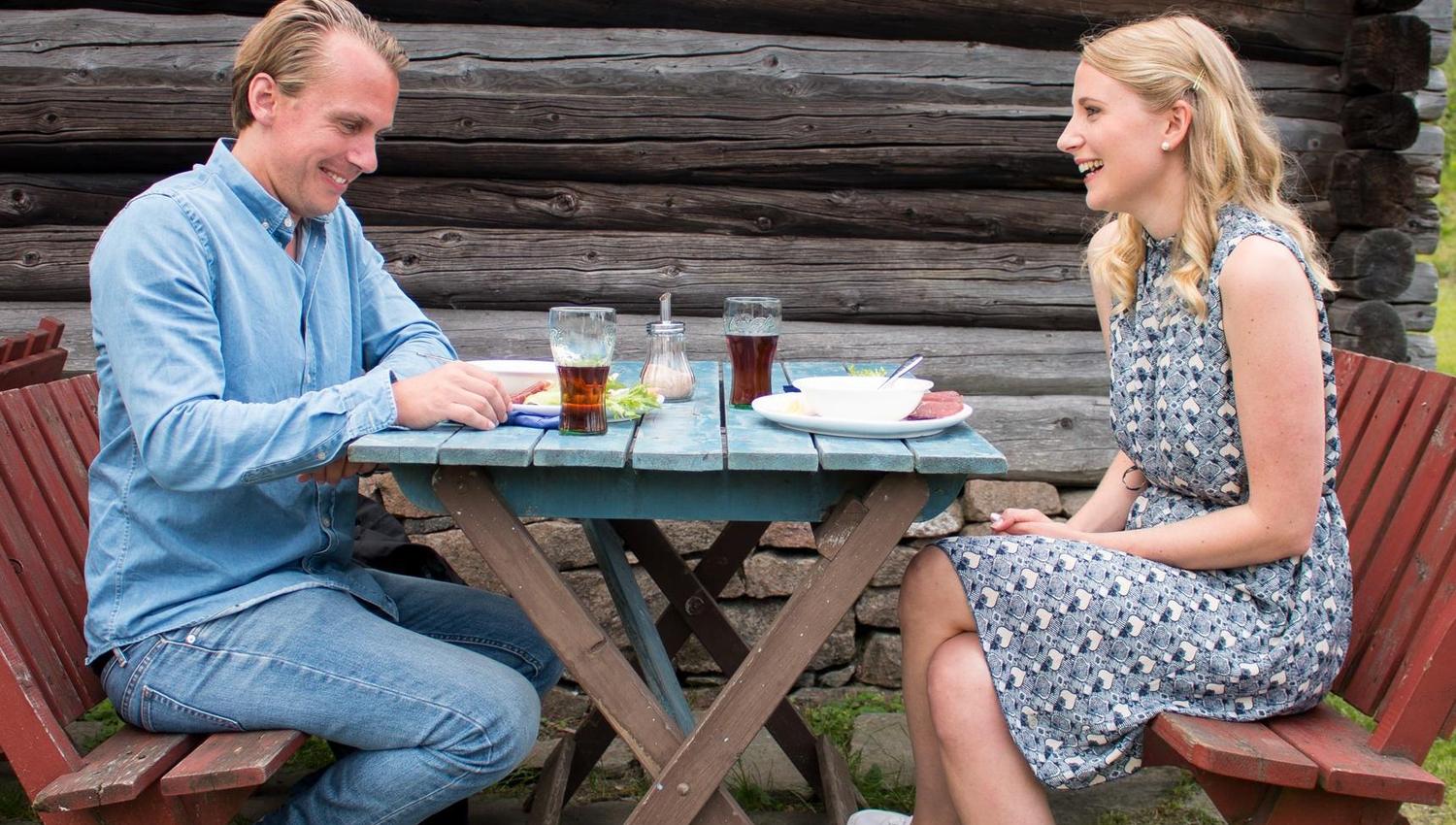 Two people eating outside at the seat cafe
