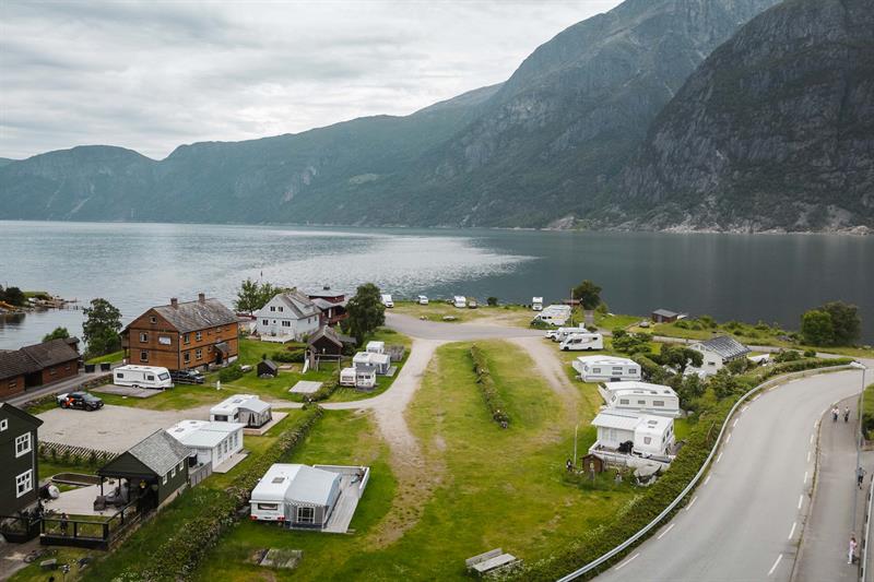 A drone photo og the campground with the fjord and mountains in the background