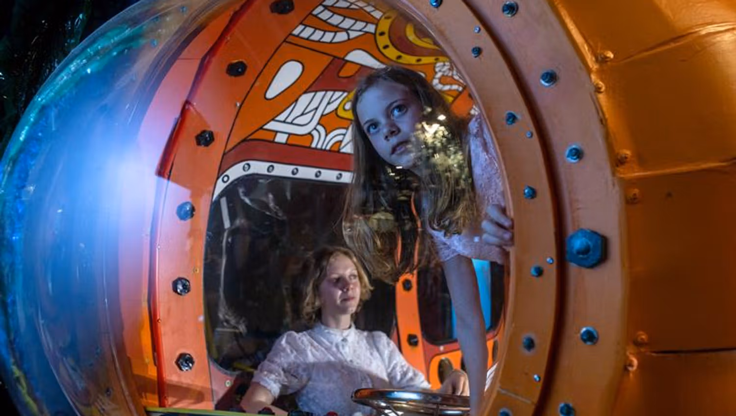 Two childen in a submarine.