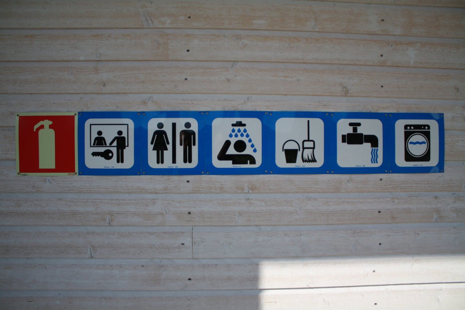 A wall with signs of the different services offered