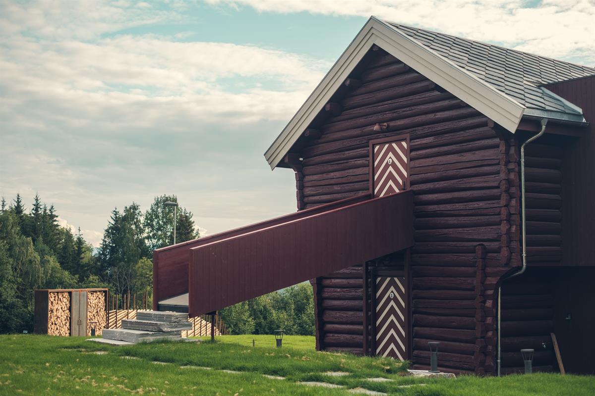 Traditional stabbur suite surrounded by green countryside.