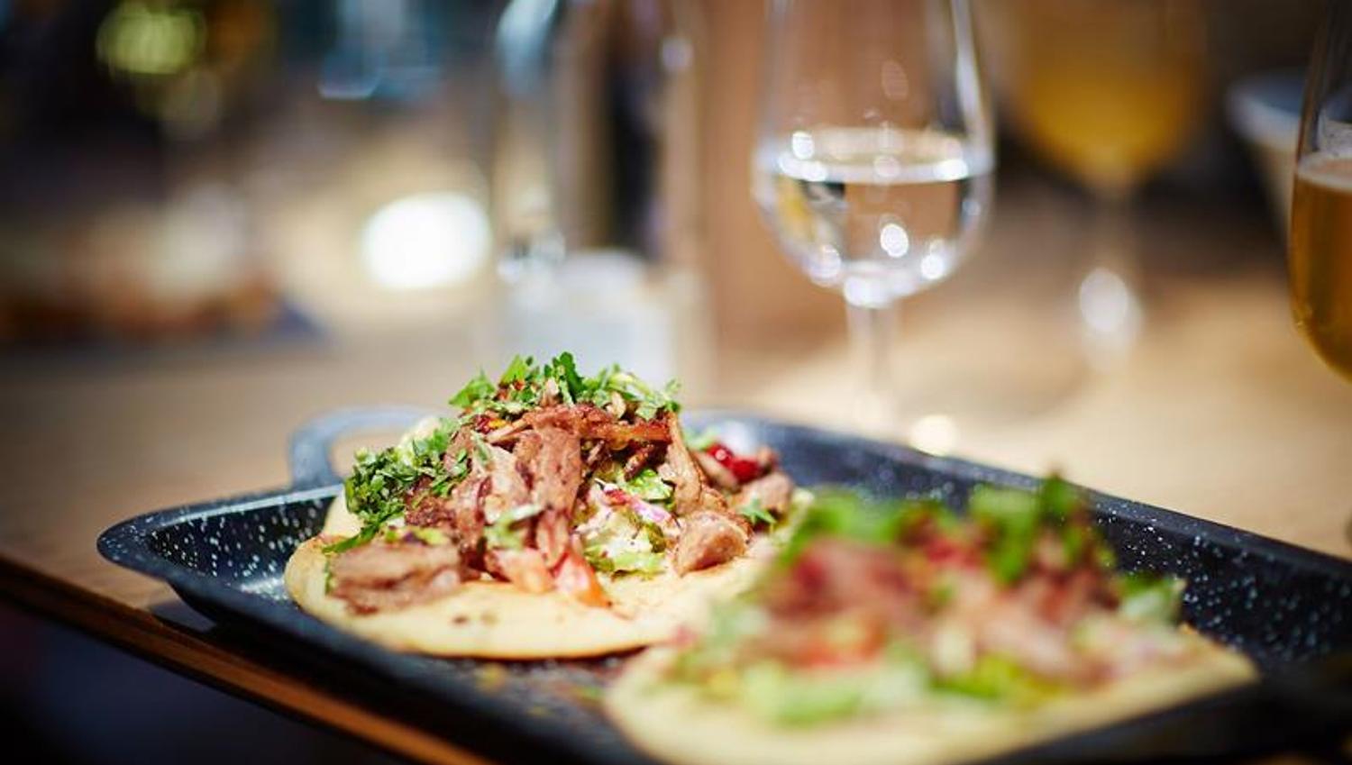 Detail photo of two tacos on a tray.