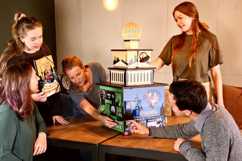 Five people solving a puzzle.