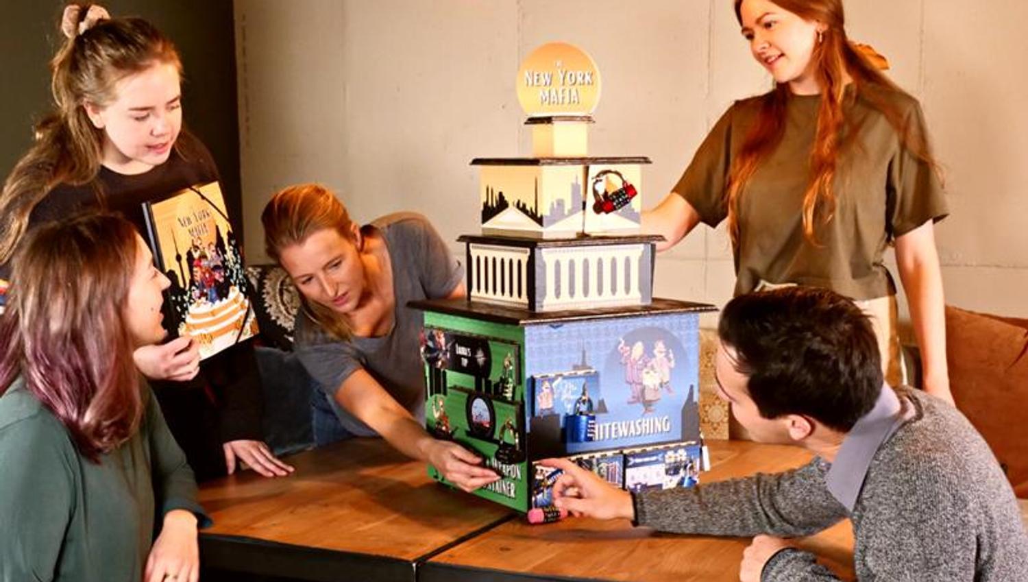 Five people solving a puzzle.