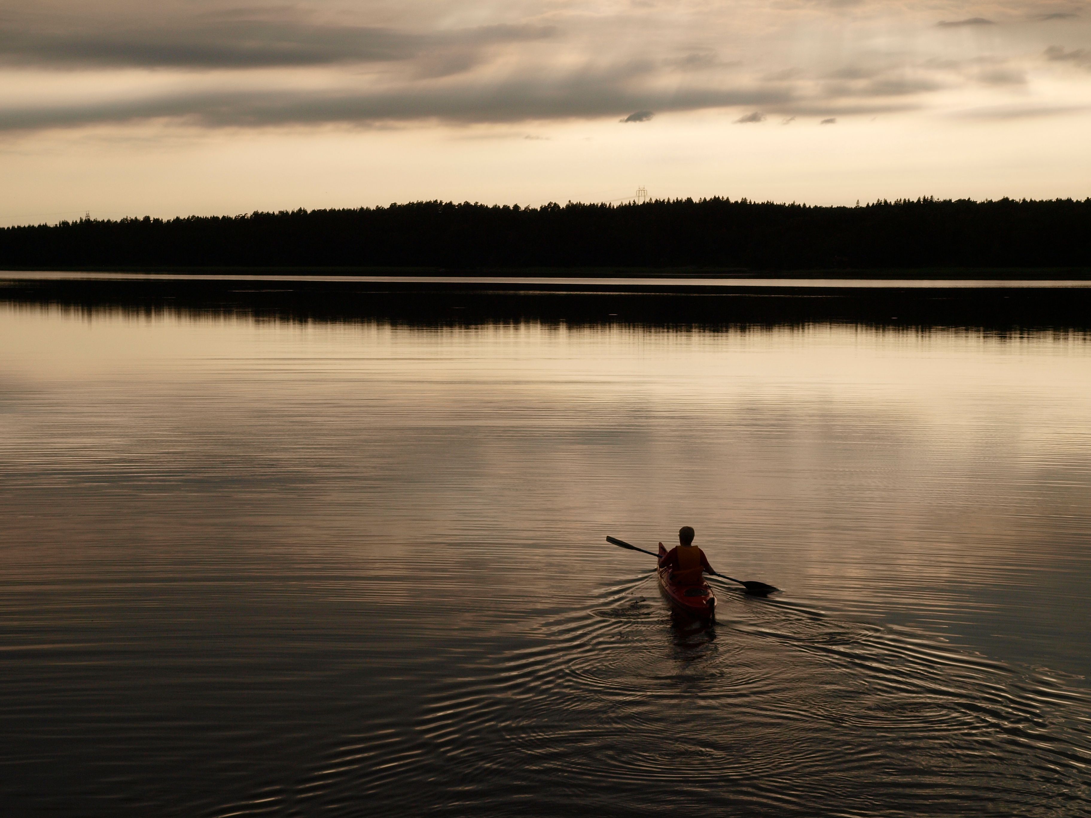A canoe paddles in the evening