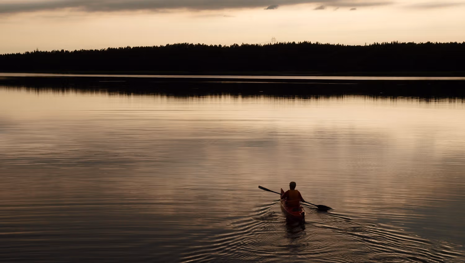 A canoe paddles in the evening