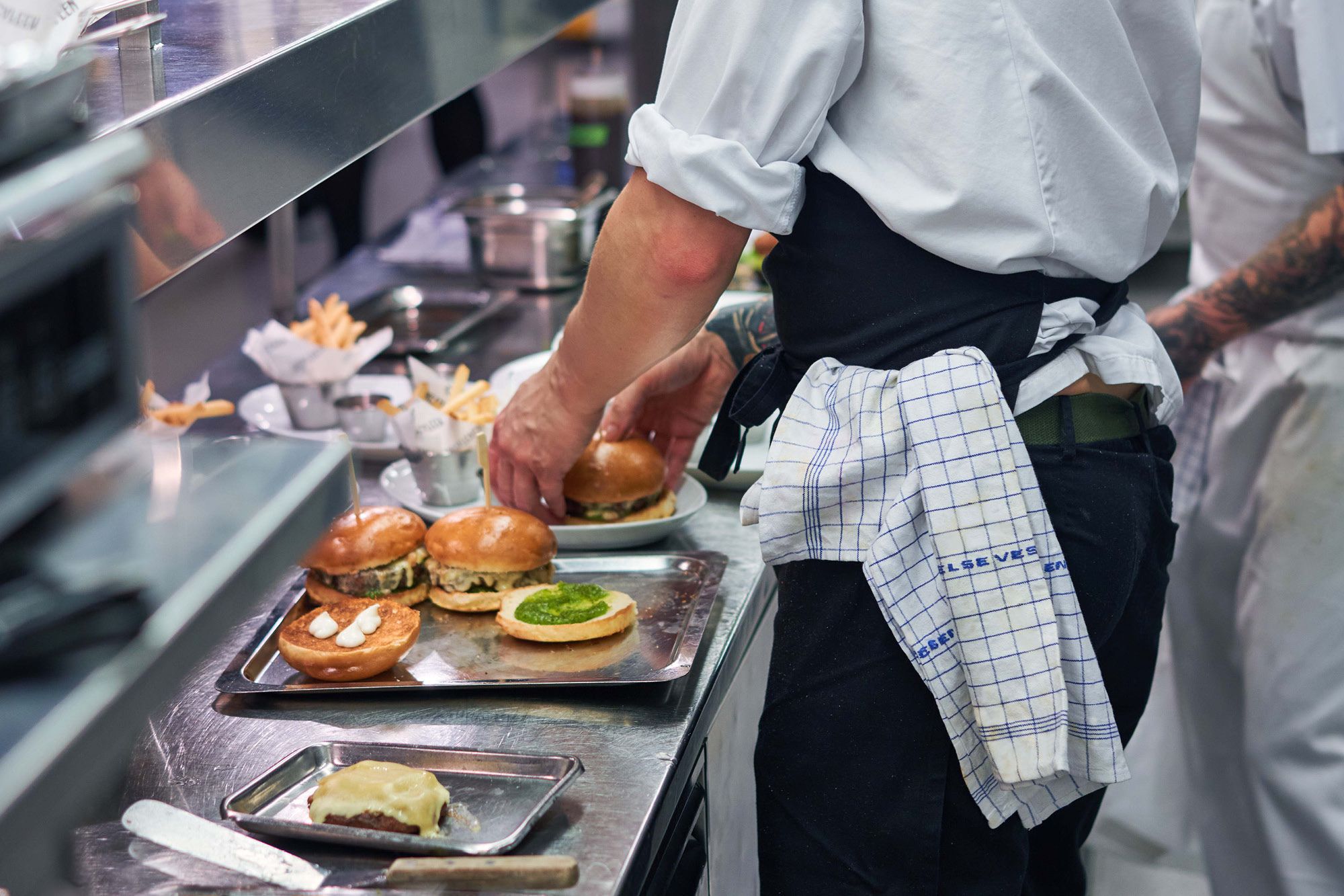 Food being prepared by chefs in the kitchen.