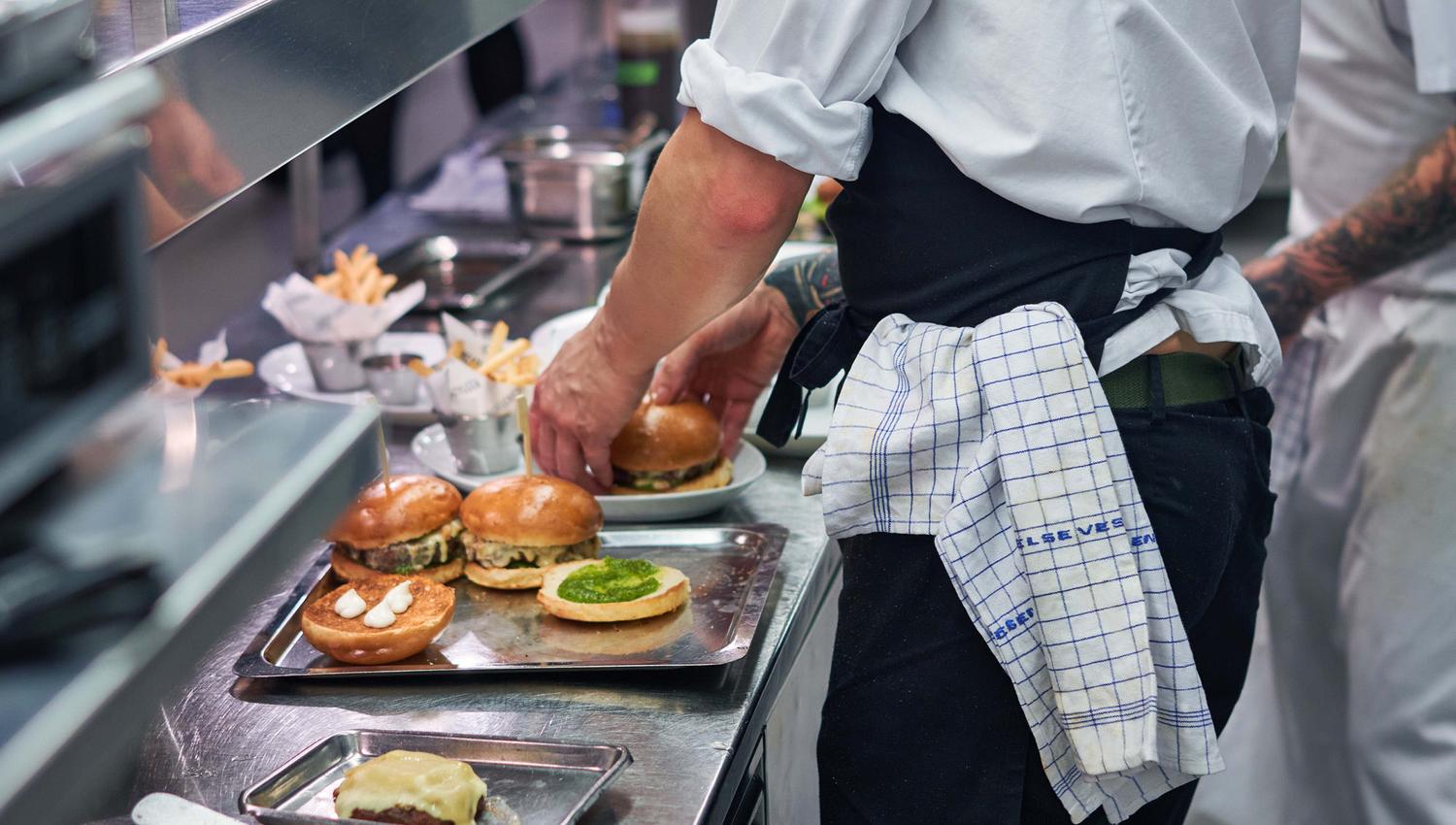 Food being prepared by chefs in the kitchen.