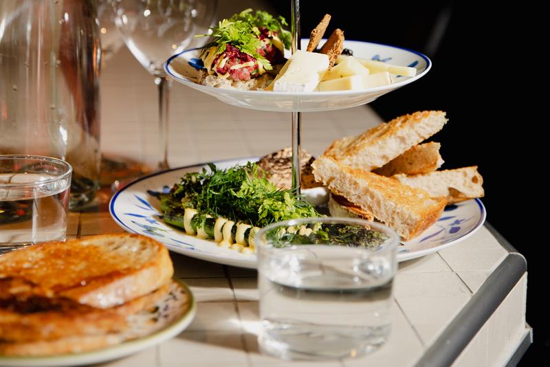Detail of various snacks and a water glass
