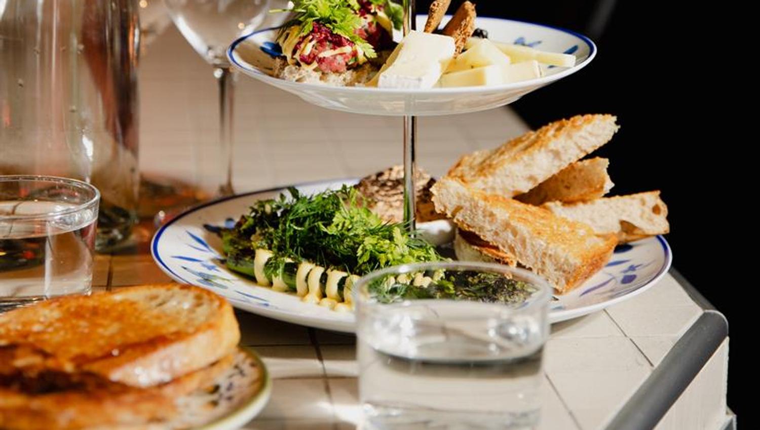 Detail of various snacks and a water glass