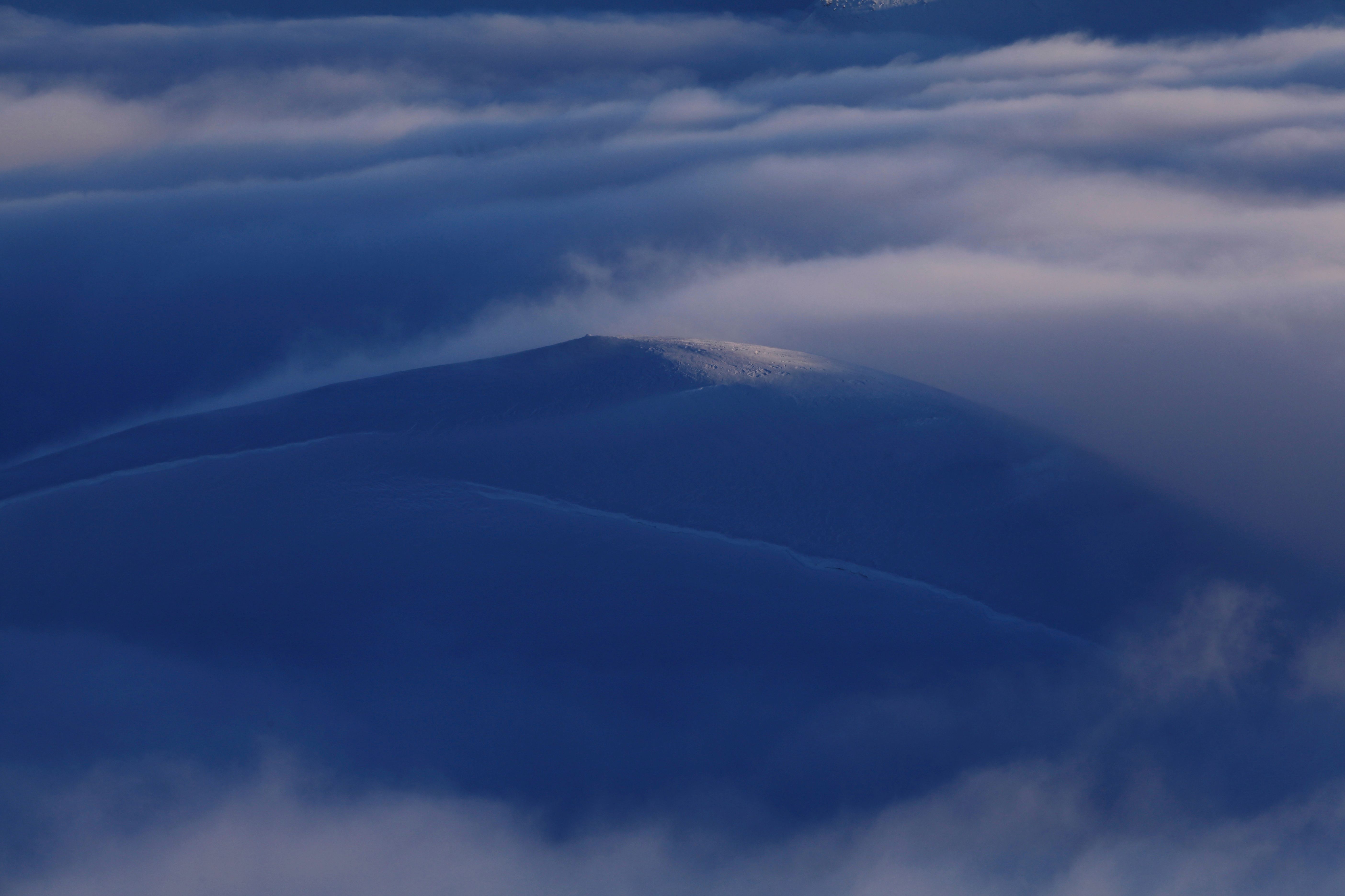 Sunlight on the summit high above the clouds 