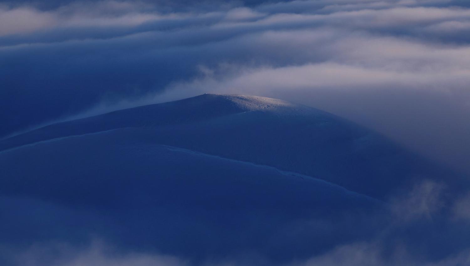 Sunlight on the summit high above the clouds