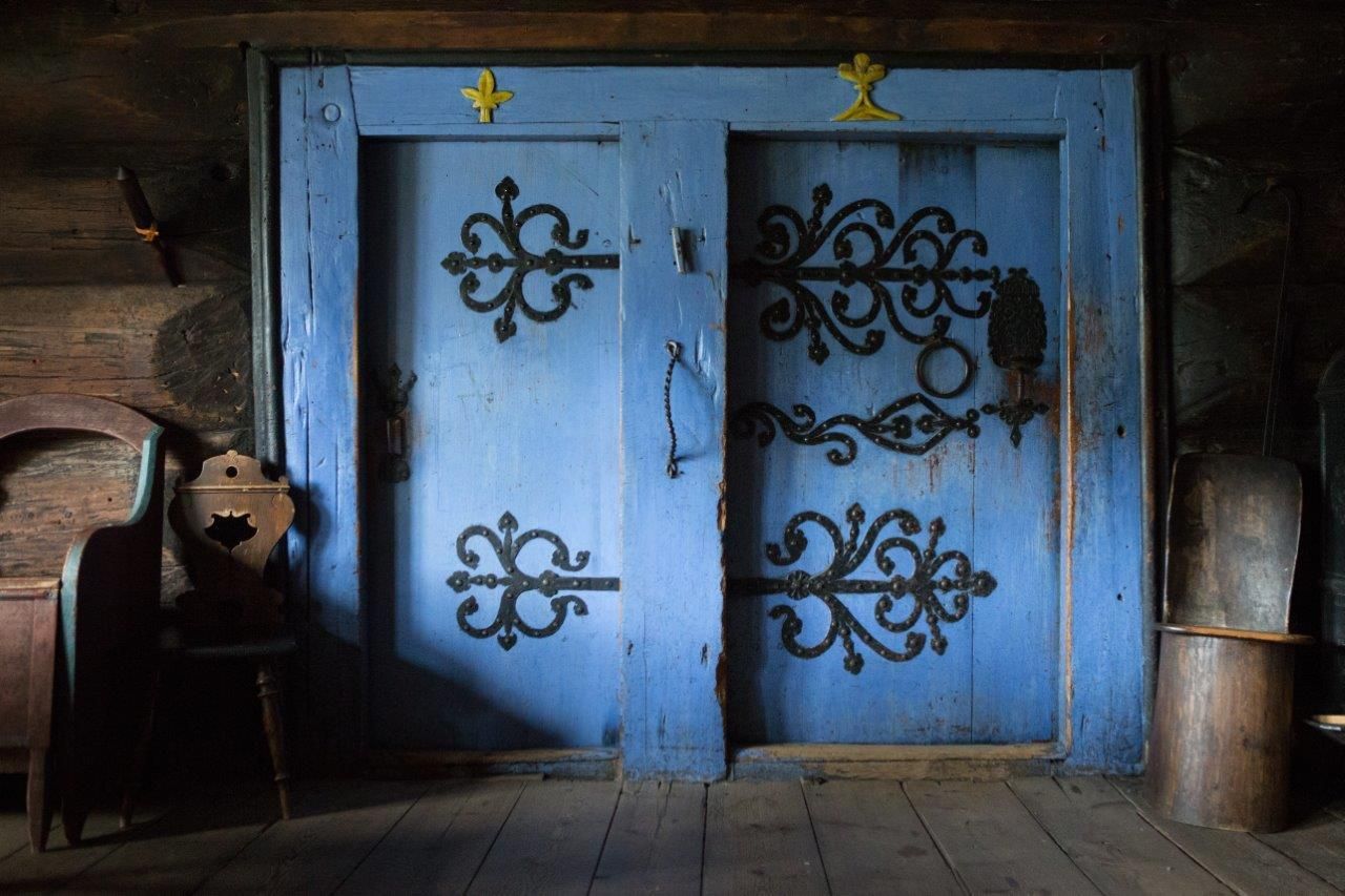Two beautiful blue doors with wrought iron. 
