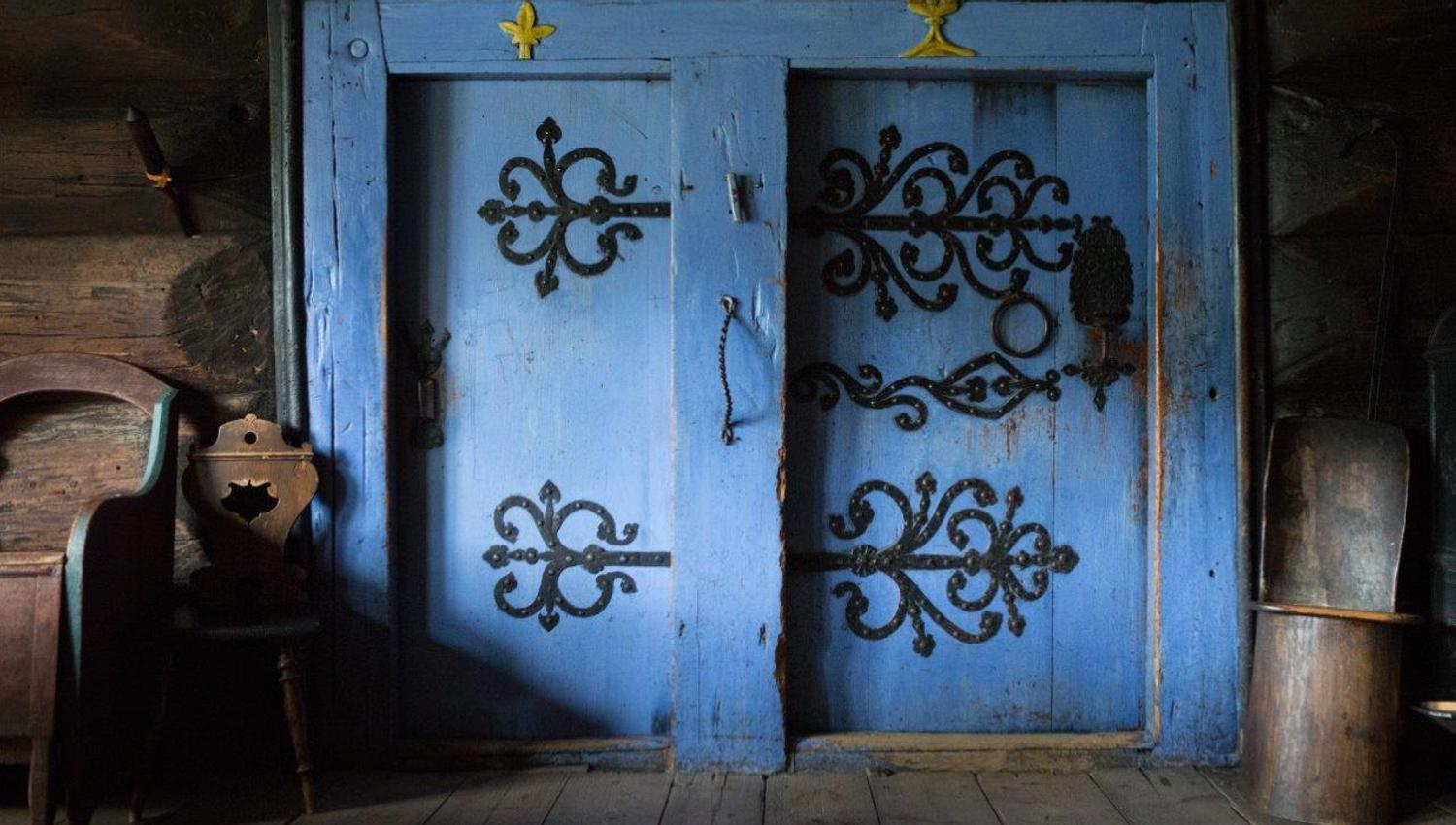 Two beautiful blue doors with wrought iron.