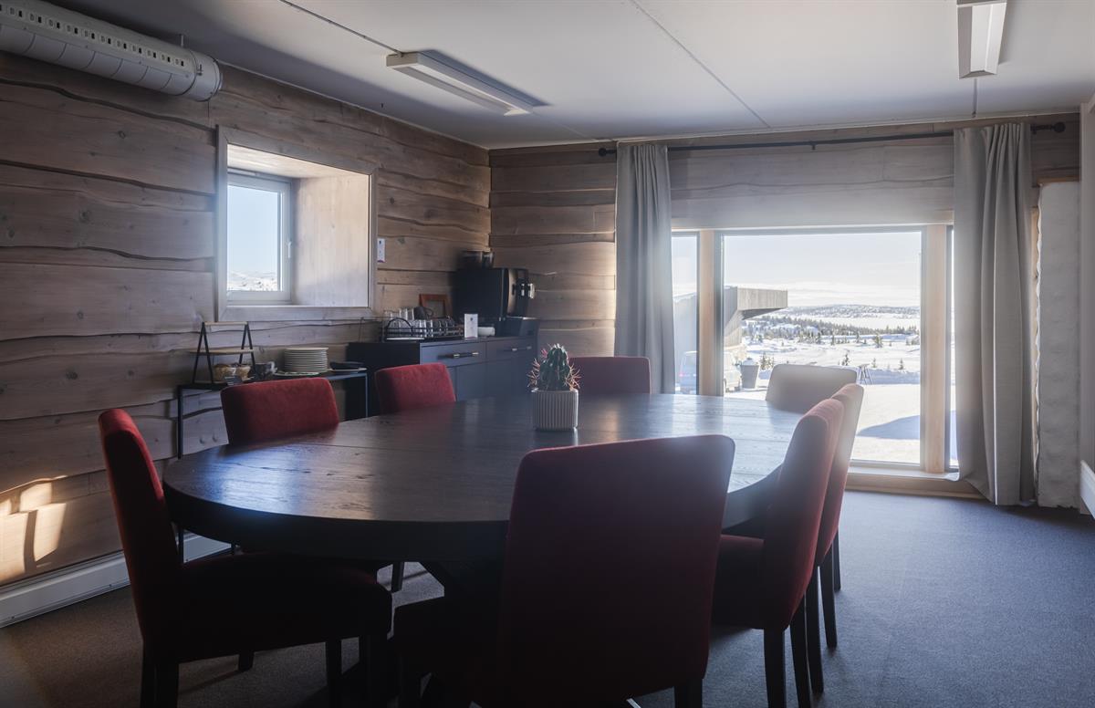 Meeting room with conference table and mountain views.