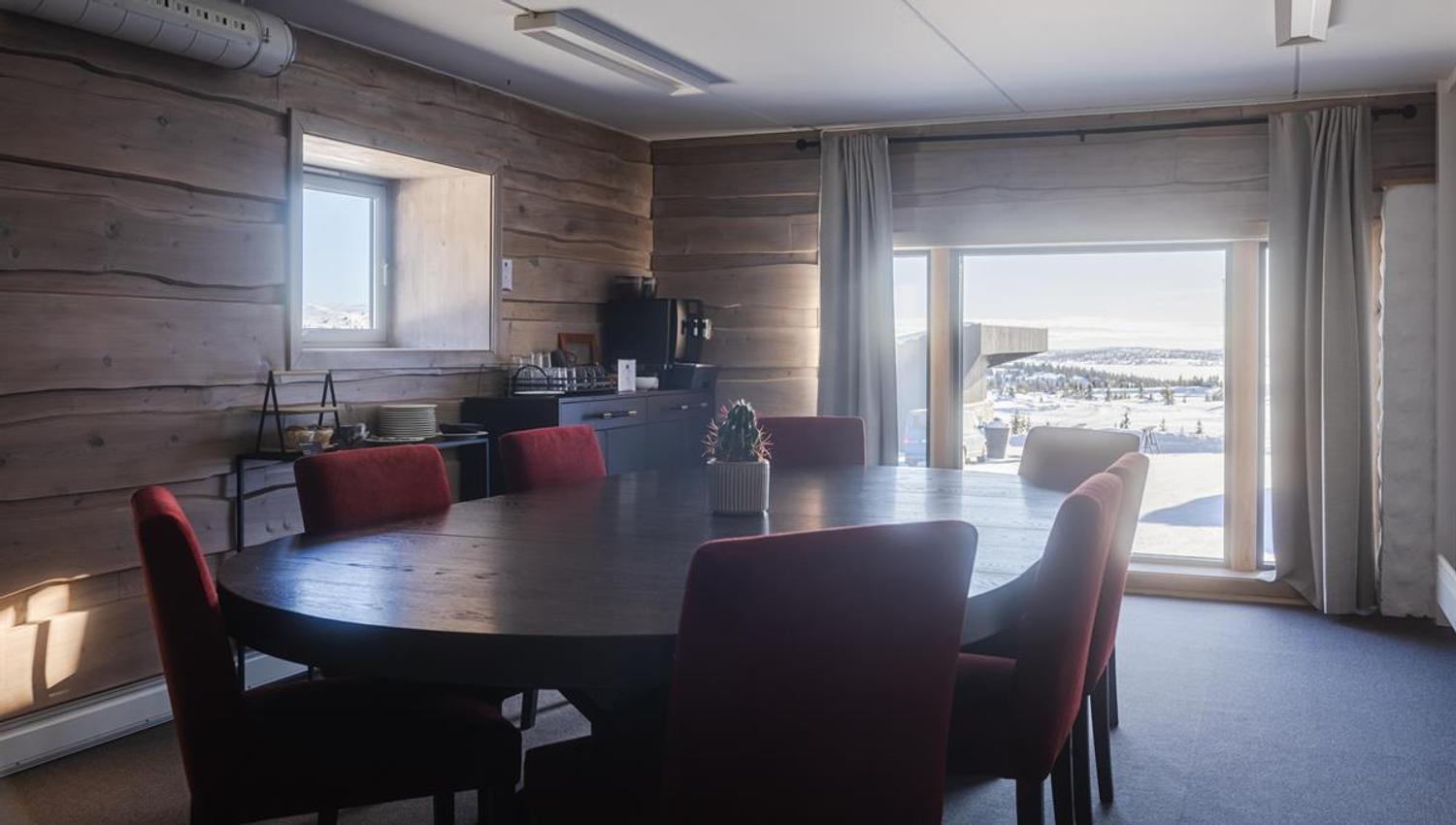 Meeting room with conference table and mountain views.