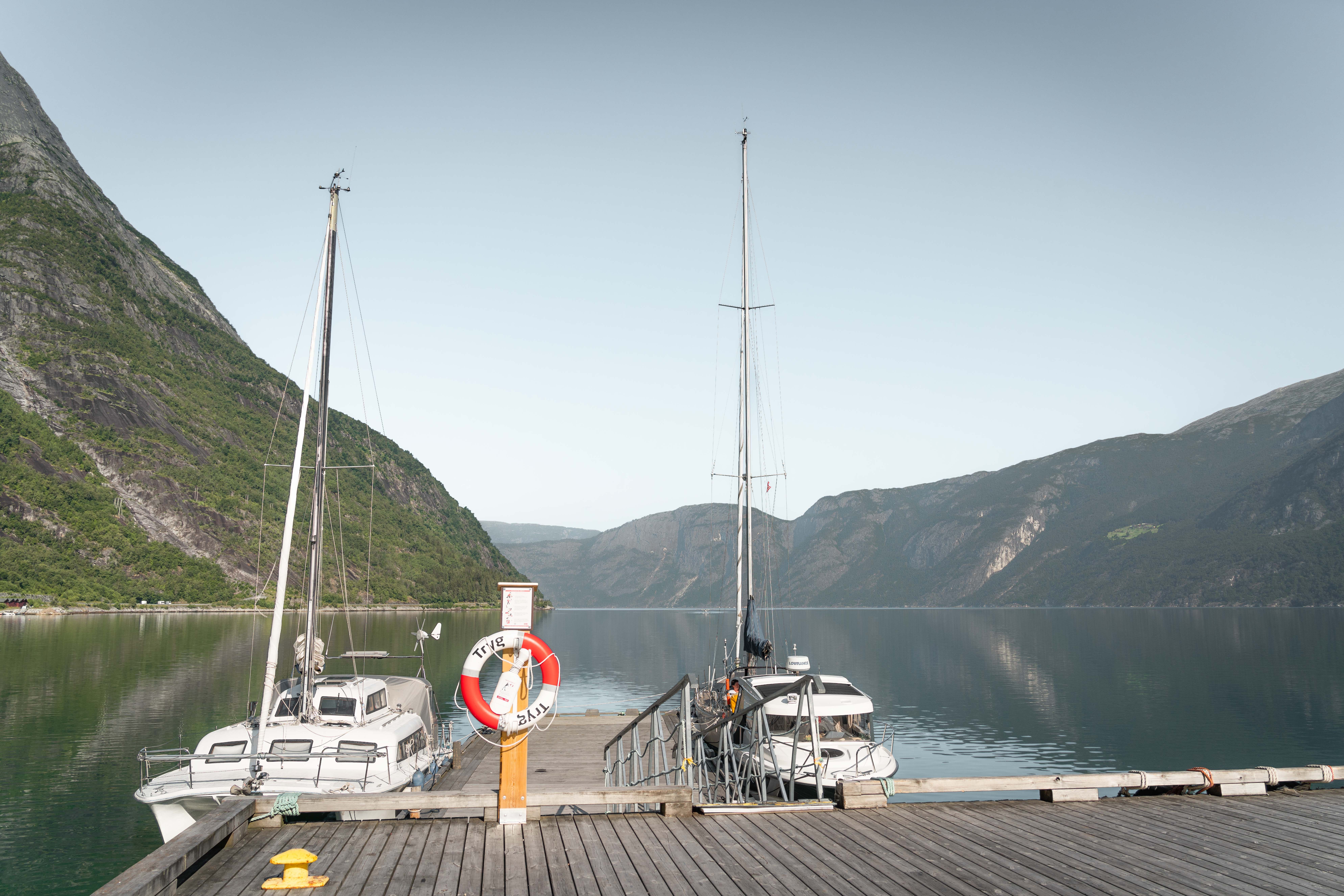 Two sailboats docked on the jetty.