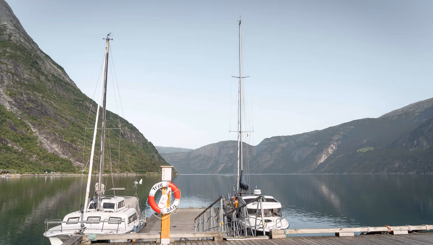 Two sailboats docked on the jetty.