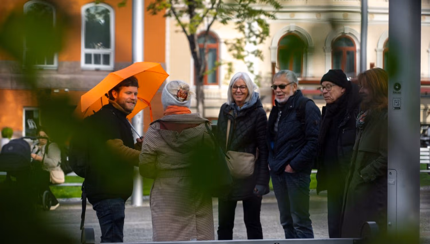 Guests listen to the stories of Tromsø near the Tromsø City Cathedral
