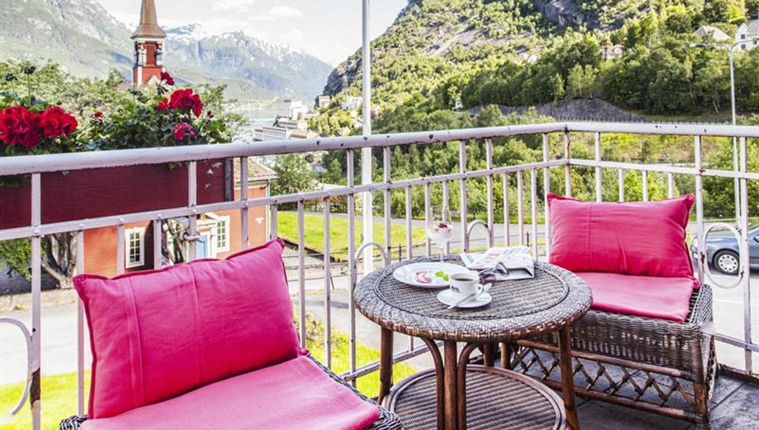 Enjoy a cup of coffee on the balcony with stunning views of the Hardangerfjord and majestic mountains.