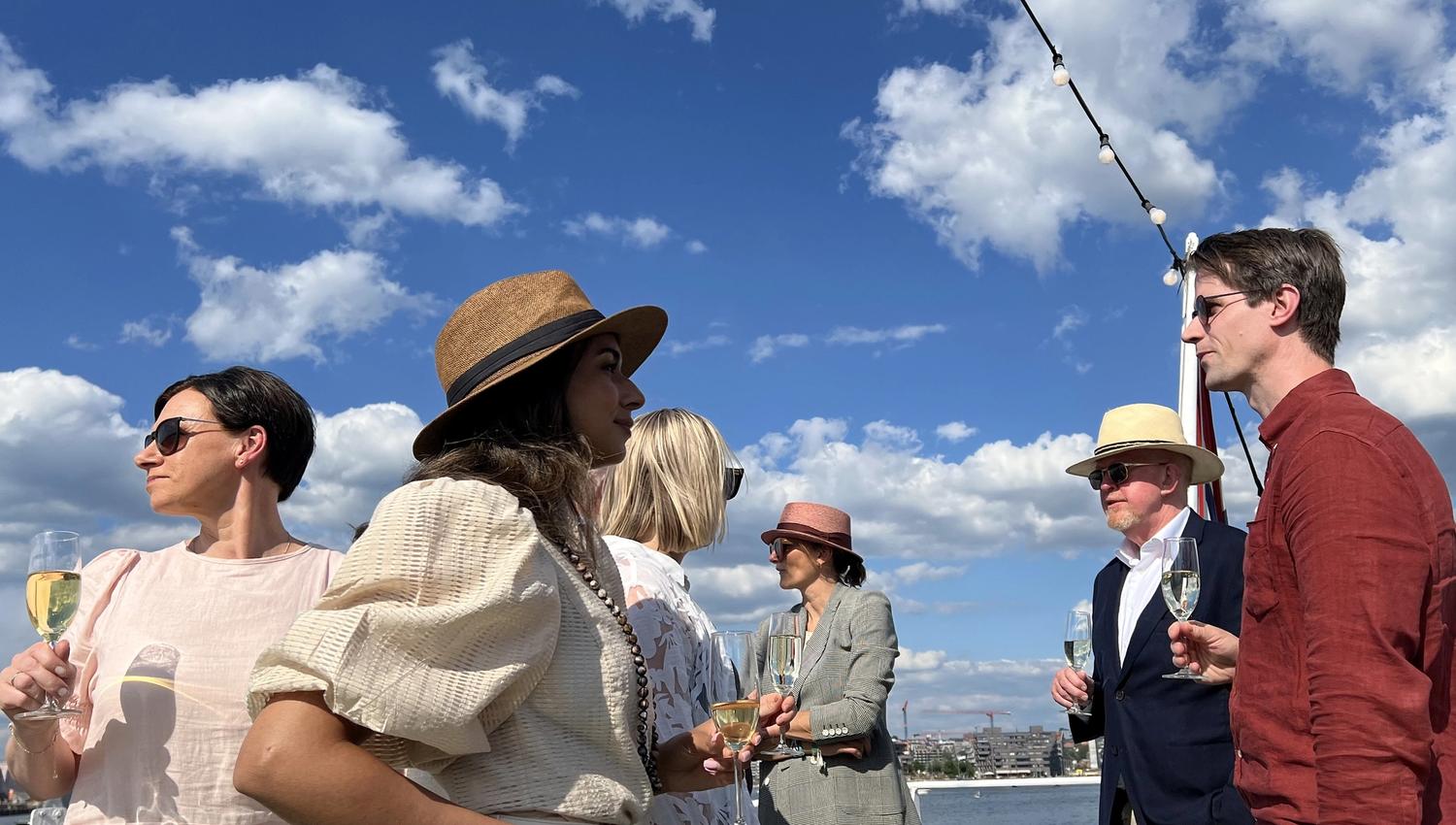 Several people with champagne glasses on deck