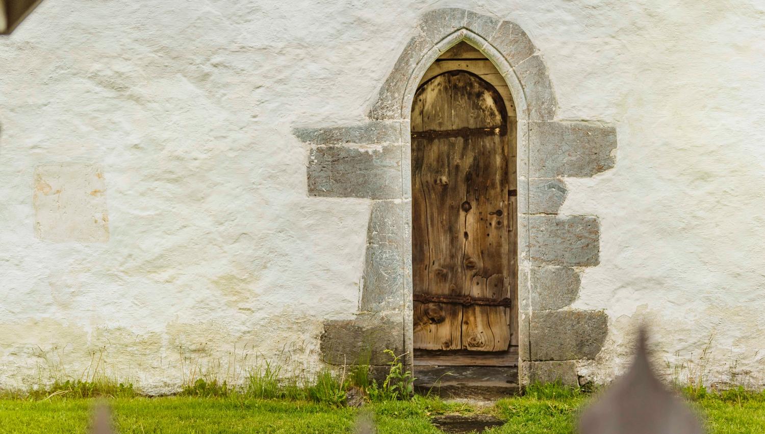 An old wooden side door to the church.