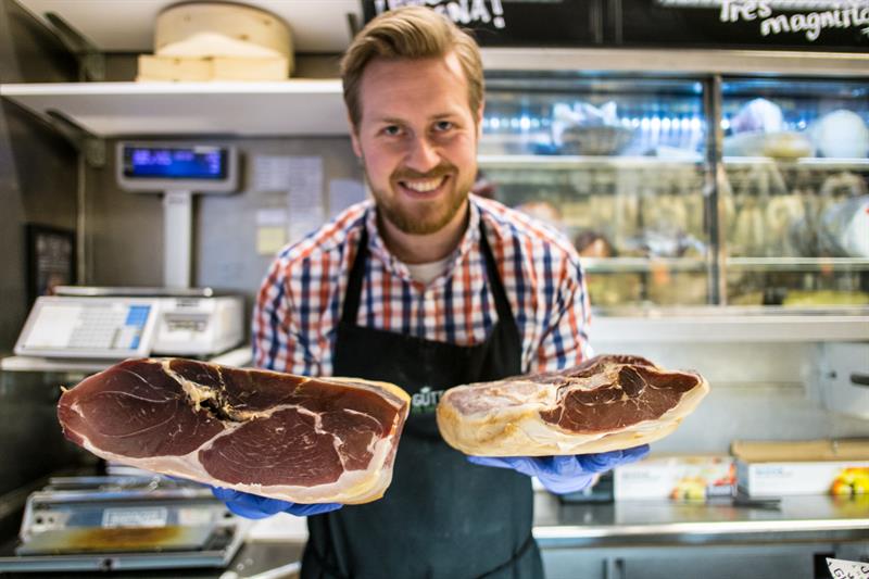 Man posing with two pieces of meat.