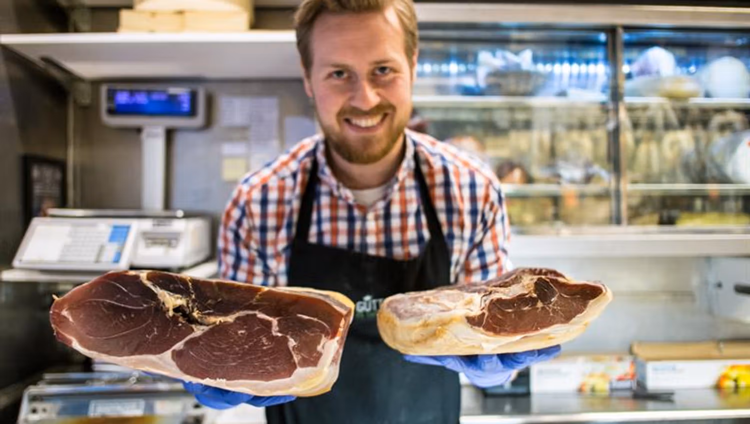 Man posing with two pieces of meat.