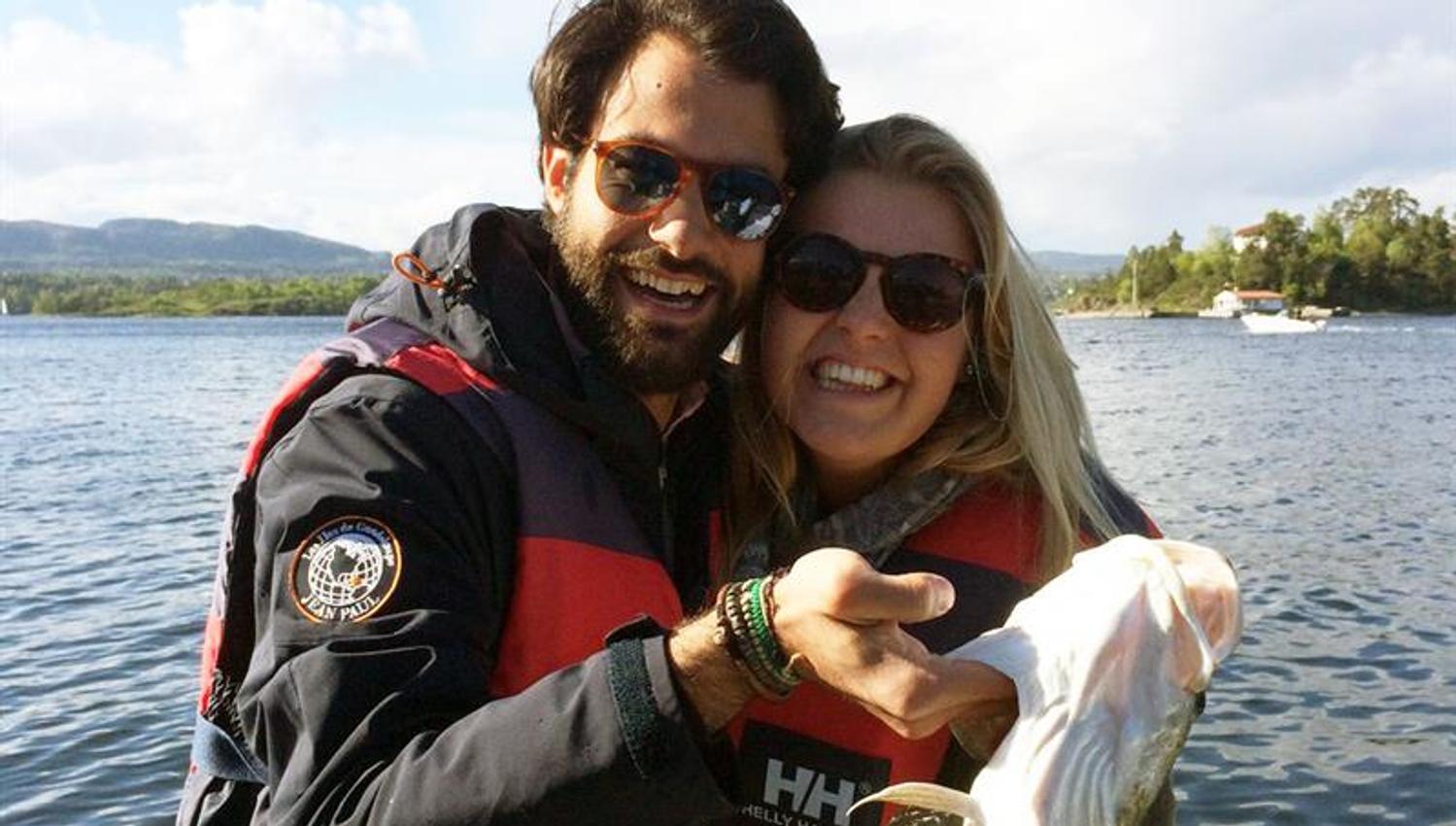 a couple with a fish in the hand