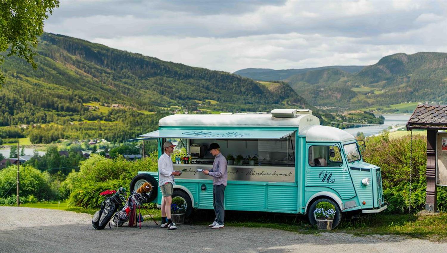 Food truck overlooking the golf course and mountains.