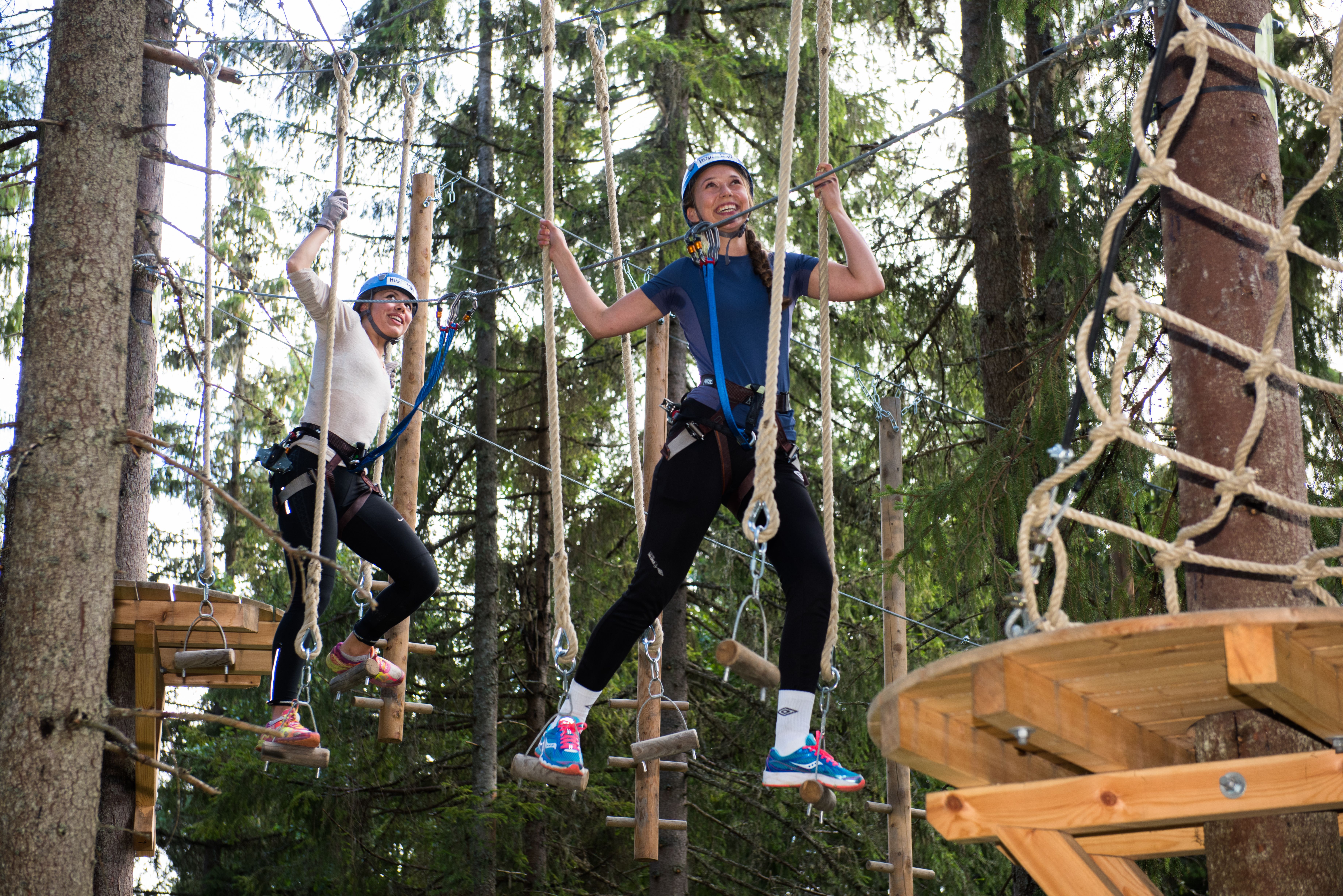 Girls in an clombing park - balancing with ropes