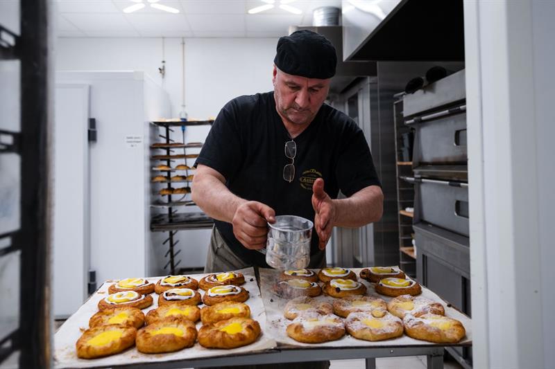 Baker decorating sweet buns.