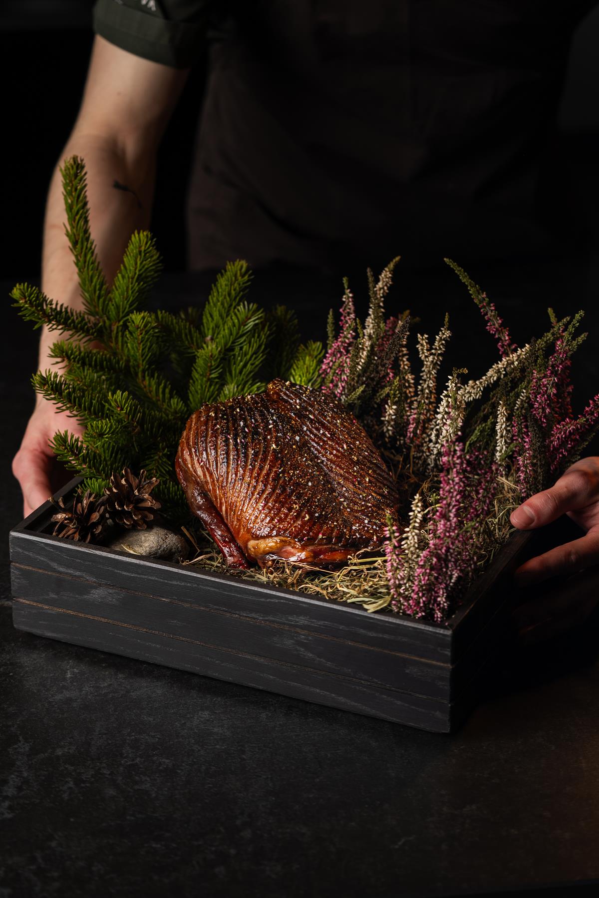 Roasted meat dish with herbs and vegetables.