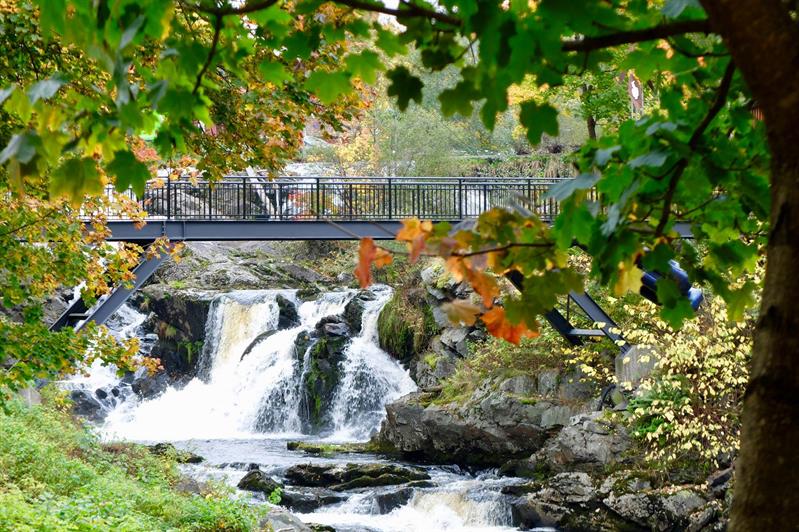 Waterfall with the bridge in autumn colors