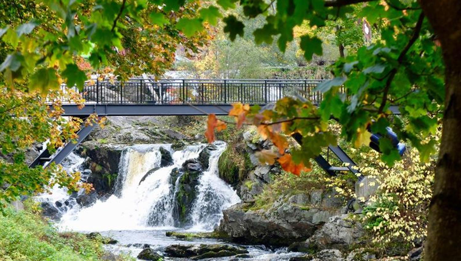 Waterfall with the bridge in autumn colors