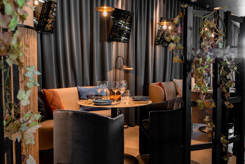 Seating section next to a table set for dining.