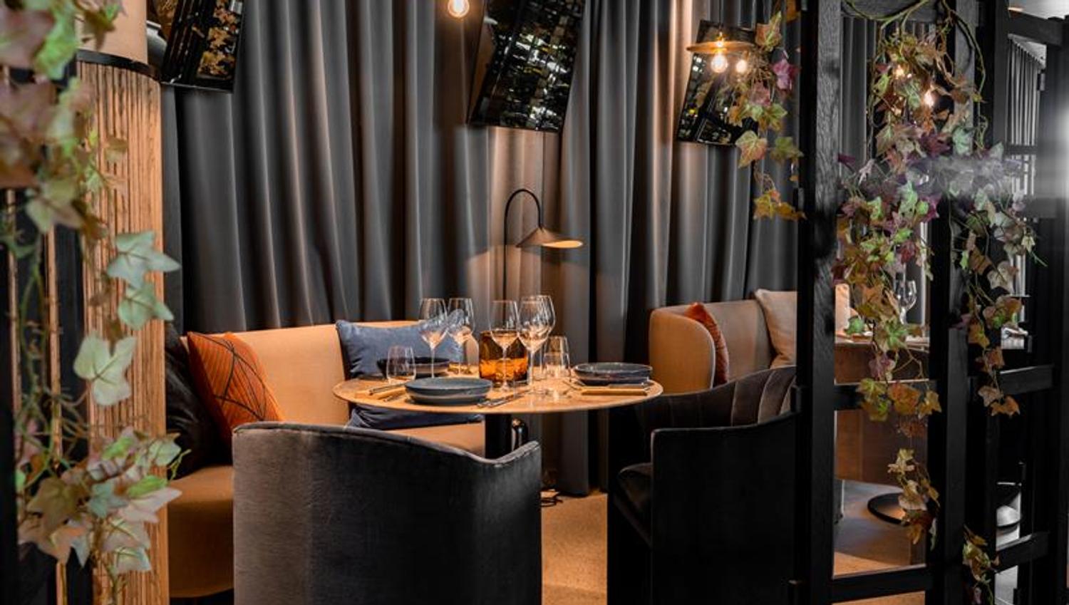 Seating section next to a table set for dining.