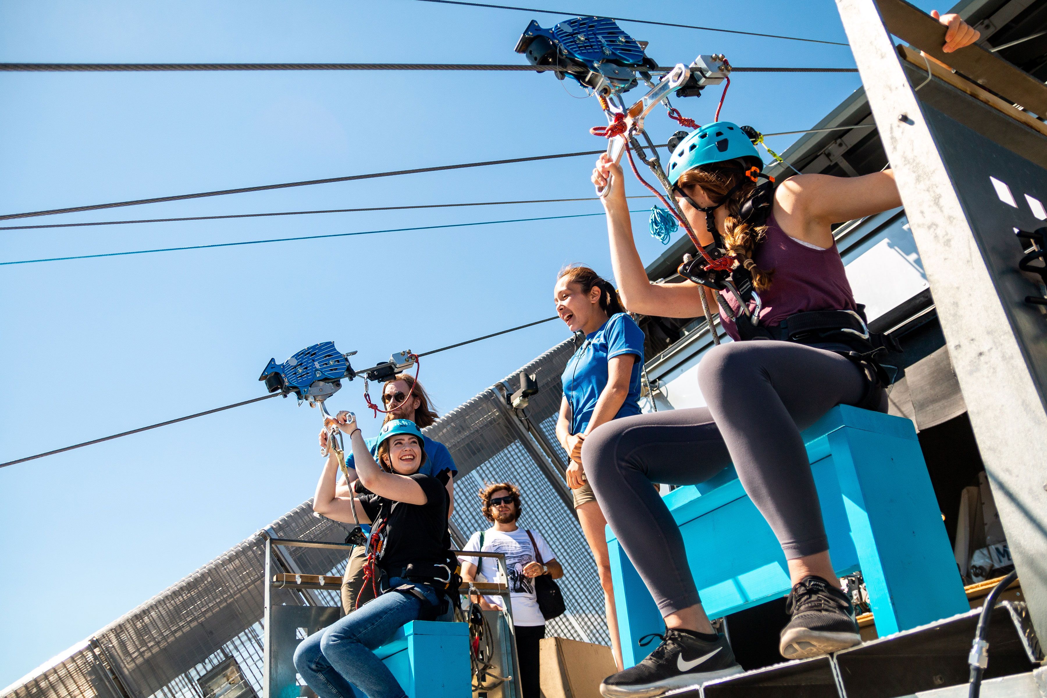 Two people getting ready to zipline.