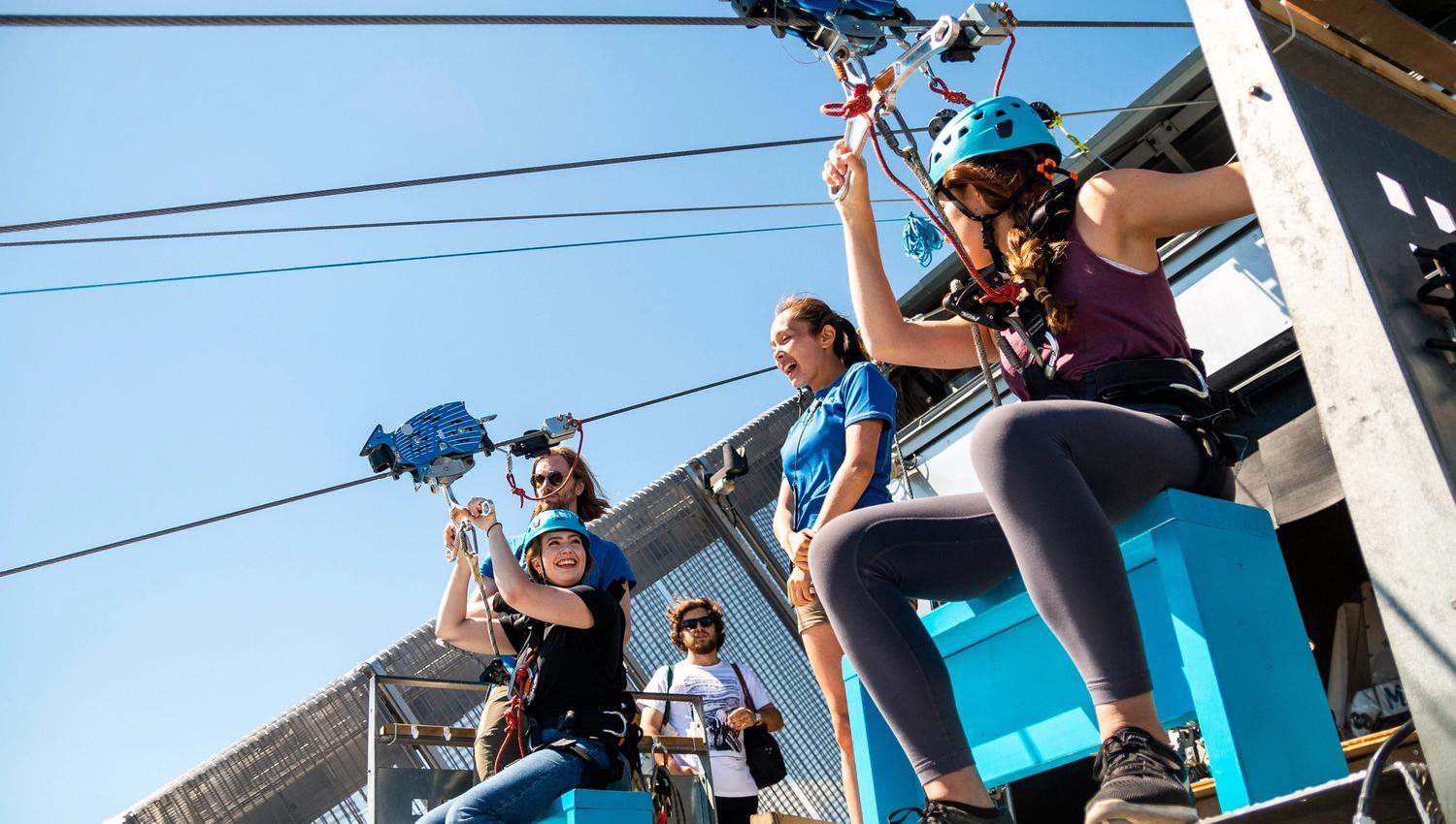 Two people getting ready to zipline.