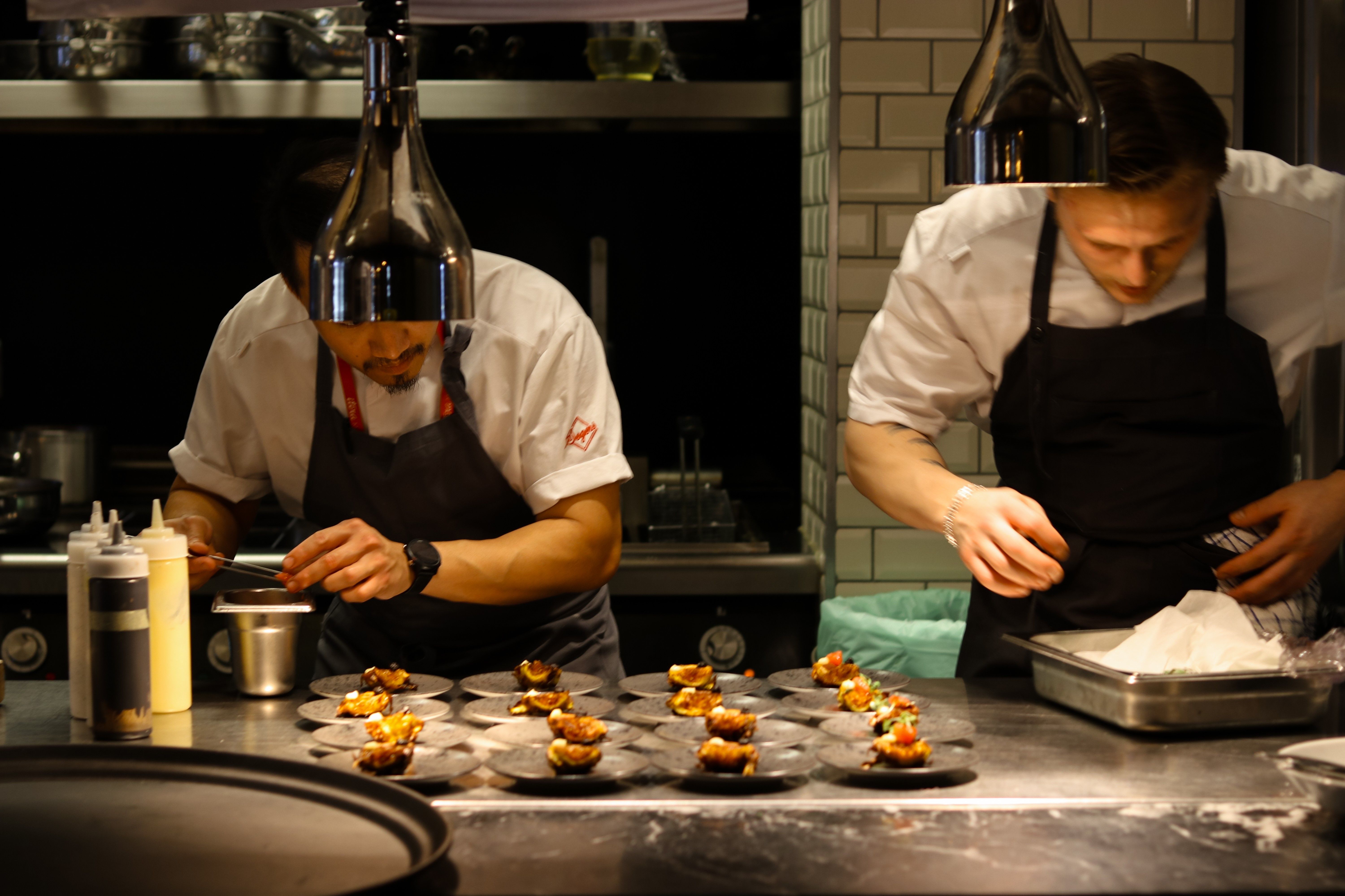 Two chefs preparing food