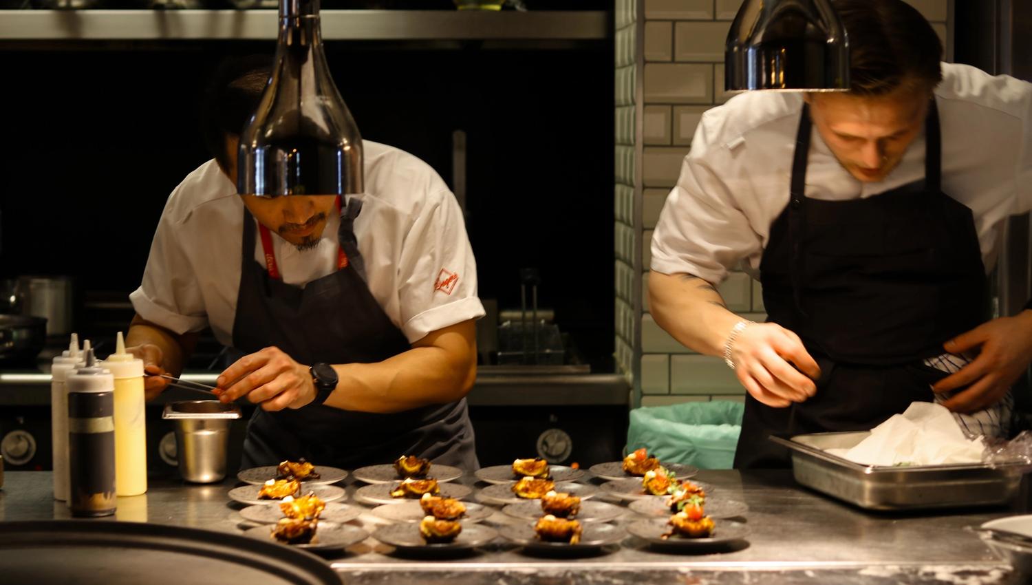 Two chefs preparing food