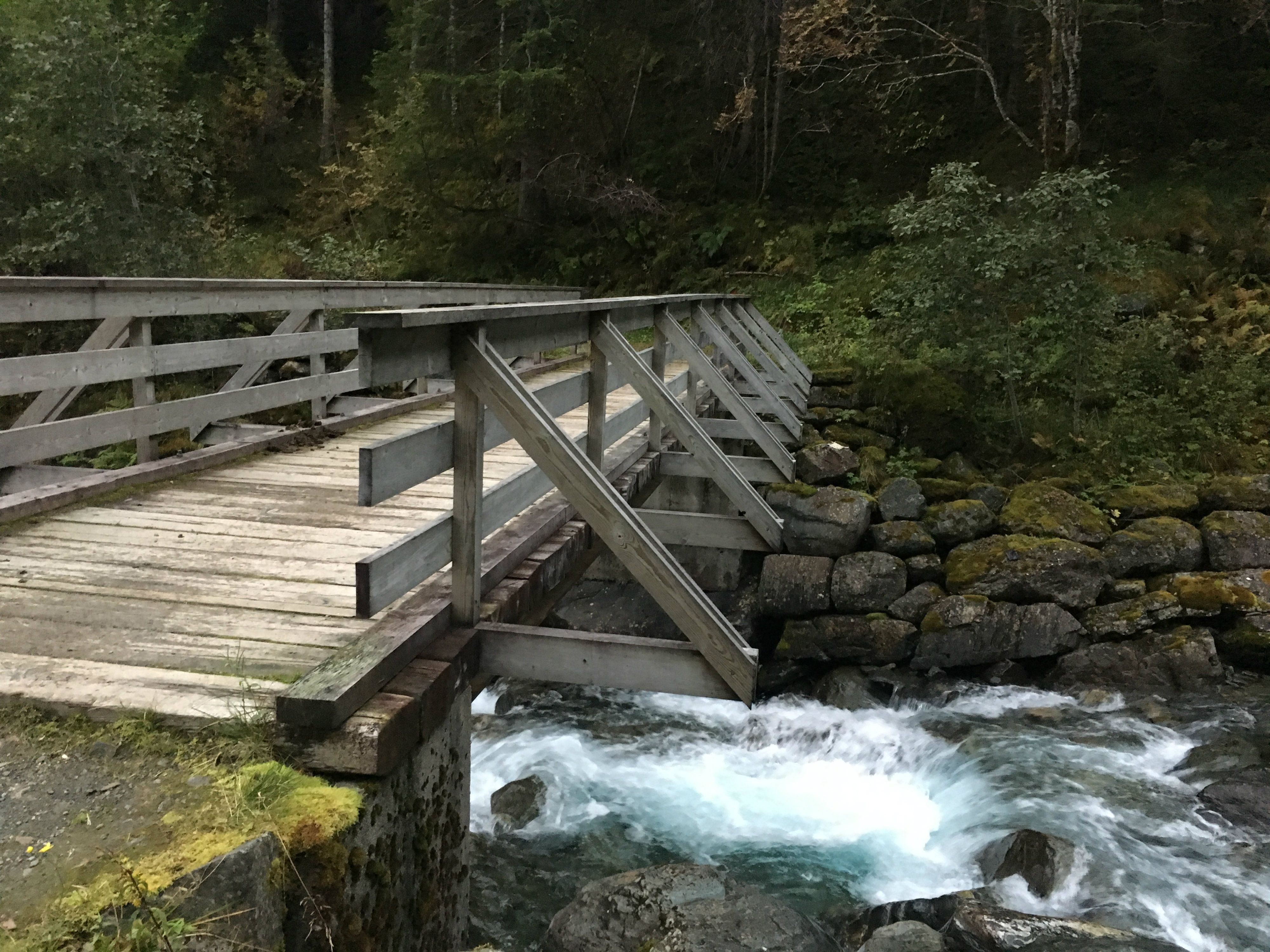 Wooden bridge crossing the rushing river in Elvedalen, Lofthus, Hardanger.