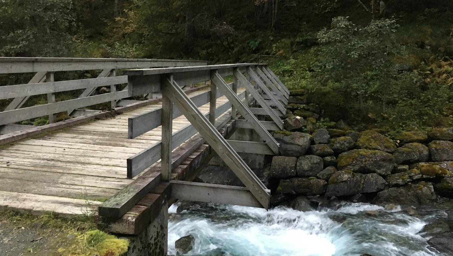 Wooden bridge crossing the rushing river in Elvedalen, Lofthus, Hardanger.