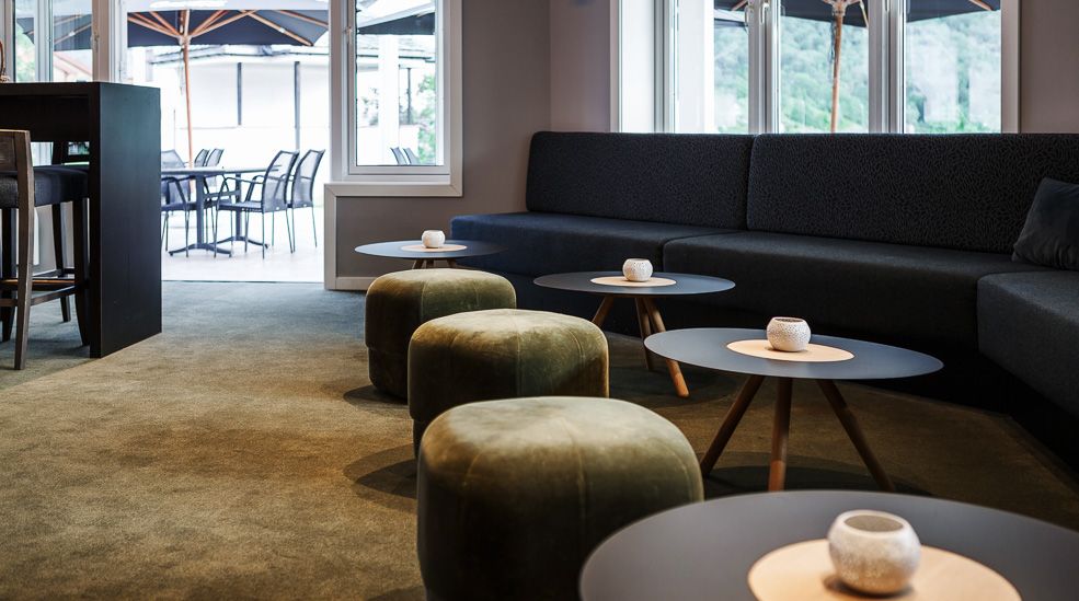 A lounge area in the bar, with a view towards the outdoor patio.