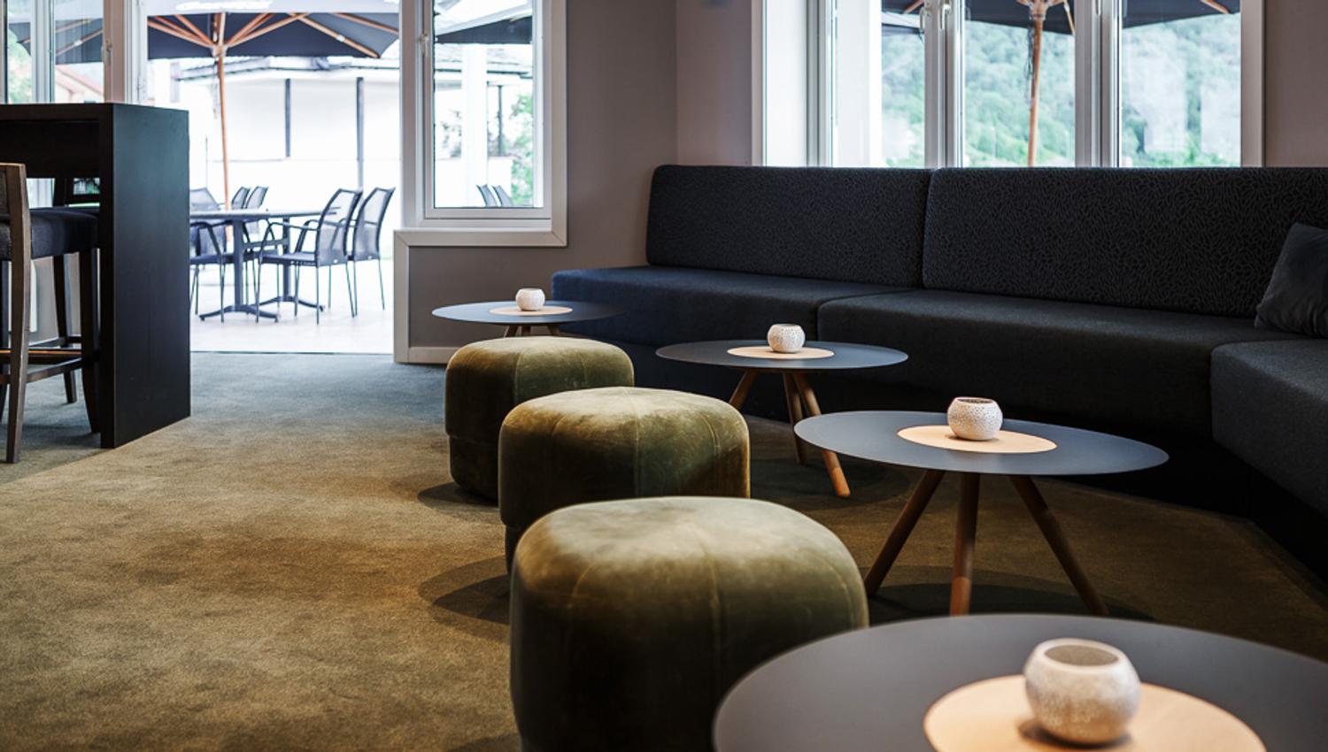 A lounge area in the bar, with a view towards the outdoor patio.