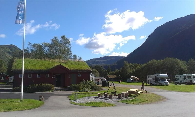 Communal area at Seim Camping with motorhomes, playground and green surroundings in Røldal.