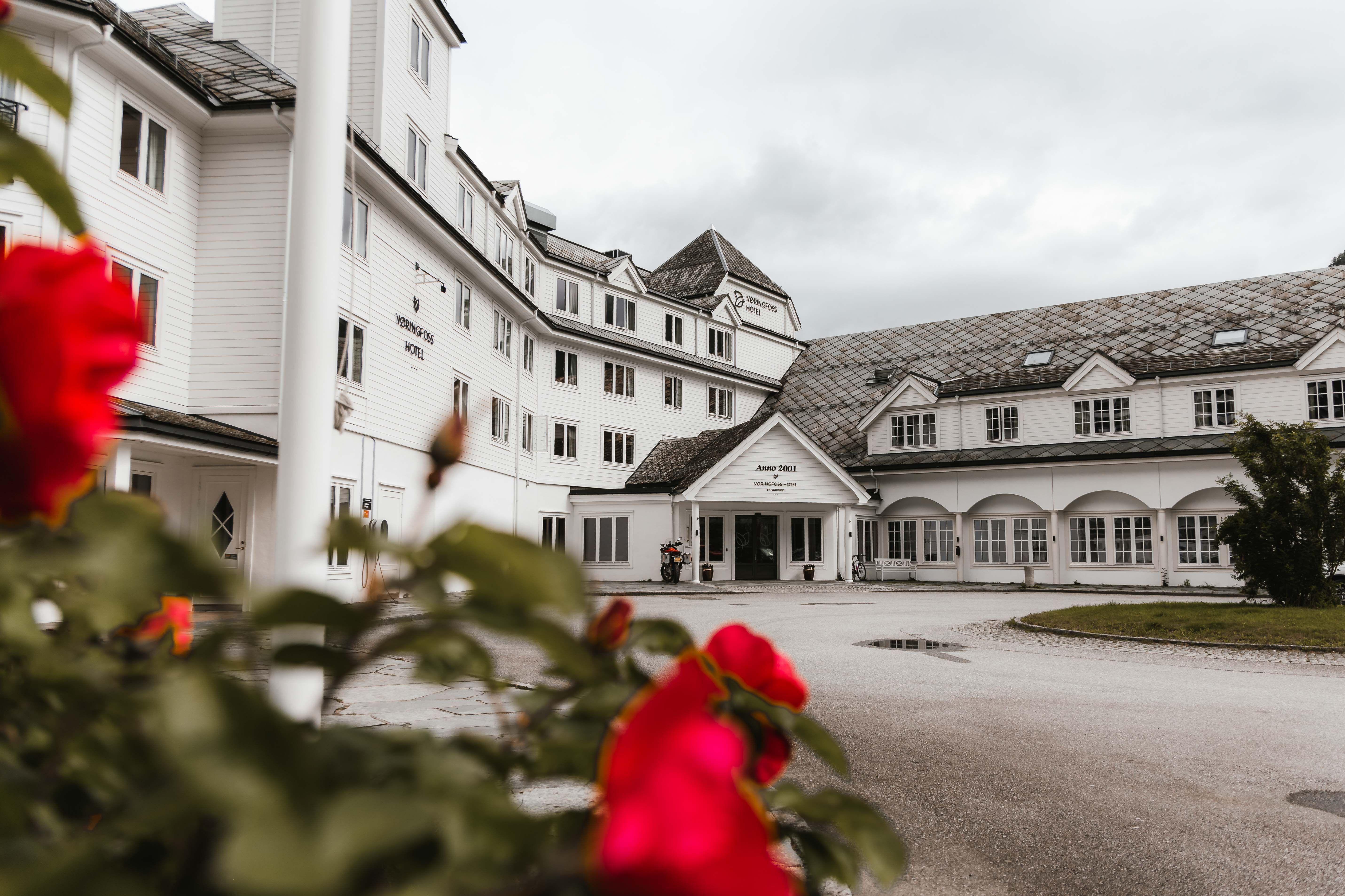 The Vøringfoss Hotel seen from the outside, with some flowers in the foreground.