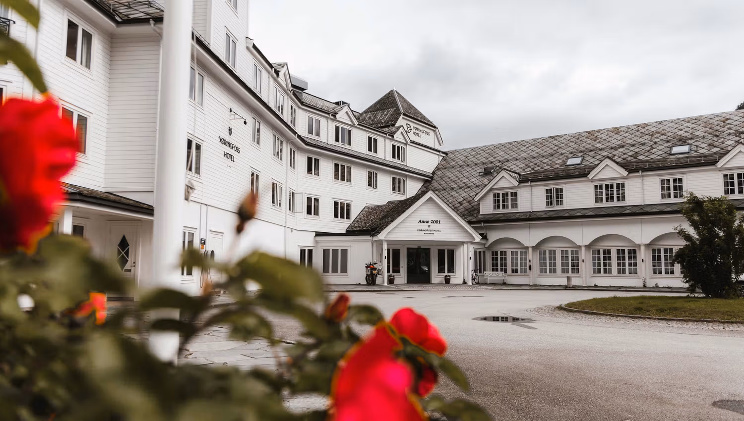 The Vøringfoss Hotel seen from the outside, with some flowers in the foreground.